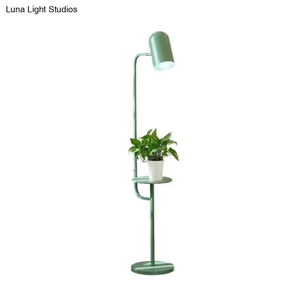 Mint Bell Metal Floor Lamp with green finish and built-in shelf holding a plant on Tampa Home & Garden Store
