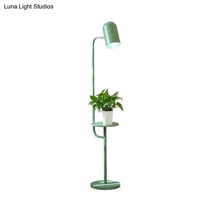 Mint Bell Metal Floor Lamp with green finish and built-in shelf holding a plant on Tampa Home & Garden Store