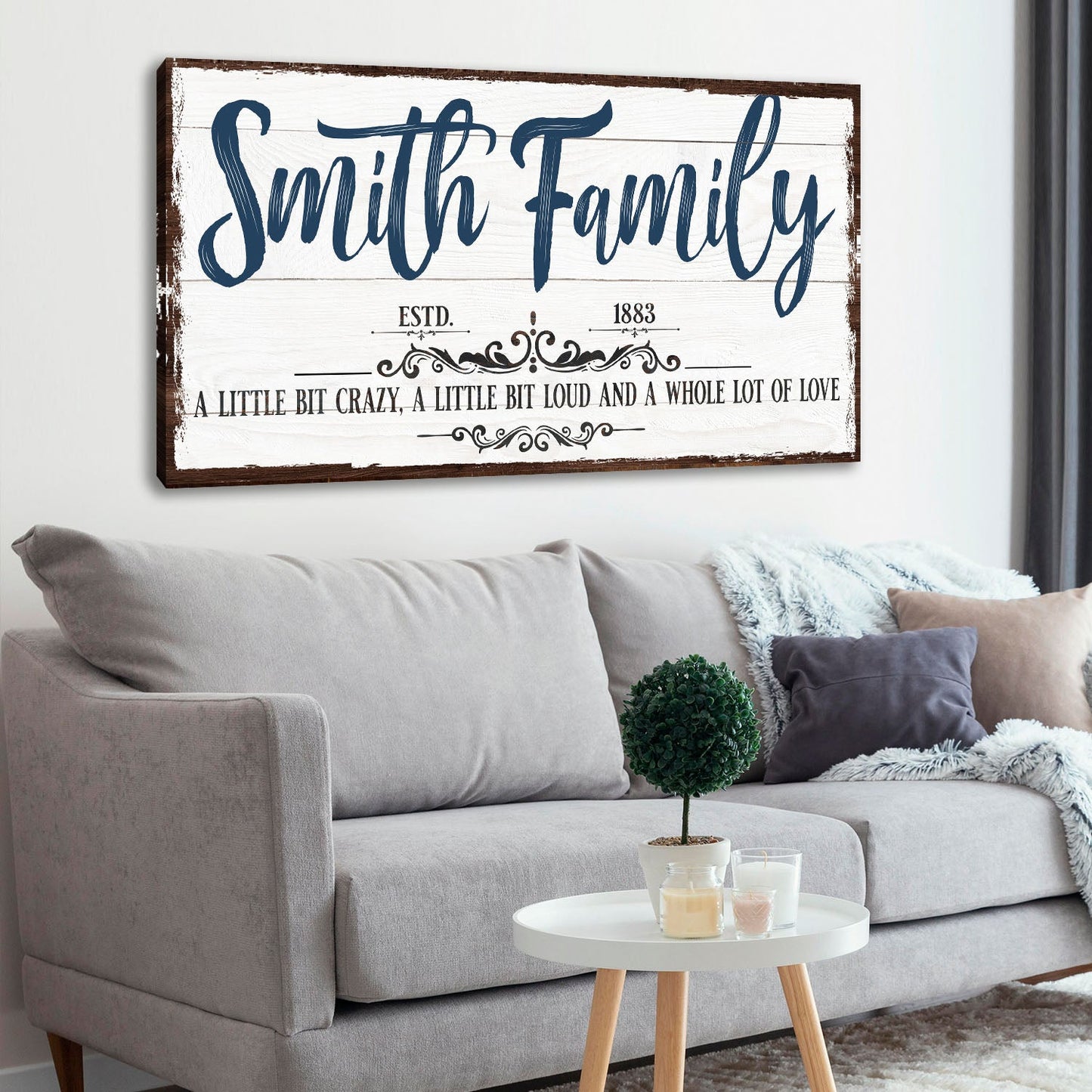 Canvas sign Smith Family with blue script on white distressed wood background on Tampa Home & Garden Store