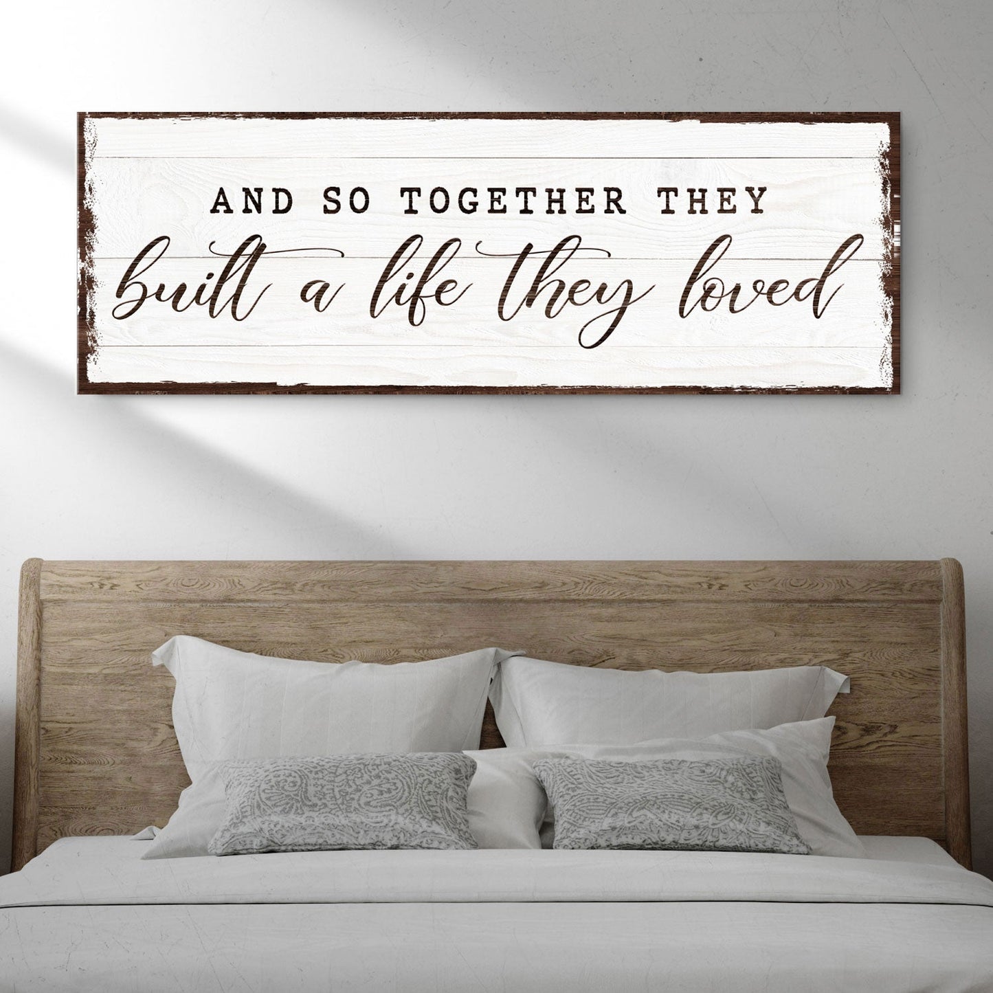 Canvas sign with whitewashed wood and frame displaying And So They Built A Life They Loved on Tampa Home & Garden Store