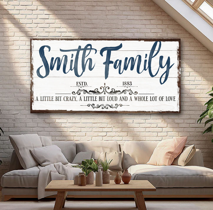 Custom Name Sign Canvas with Smith Family blue script on rustic white frame brick wall on Tampa Home & Garden Store
