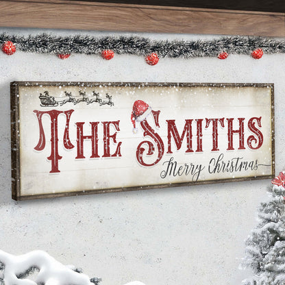 Christmas Family Name Sign IV canvas with red lettering and Santa sleigh motif framed in wood on Tampa Home & Garden Store