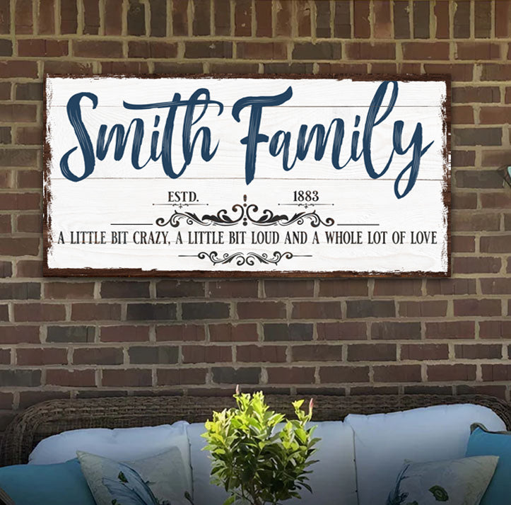 Tailored Canvases family sign canvas with Smith Family in blue script on white wood backdrop on Tampa Home & Garden Store