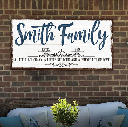 Canvas name sign Smith Family on whitewashed board with navy script and decorative border on Tampa Home & Garden Store