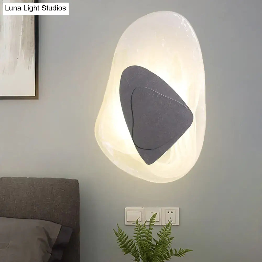 Clear glass rock sconce with dark grey interior stone, wall-mounted ambient light by Decorbites on Tampa Home & Garden Store