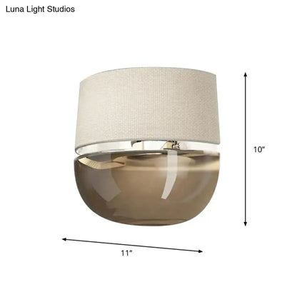 Amber arched tan glass sconce with cream fabric shade and chrome accent by Decorbites on Tampa Home & Garden Store