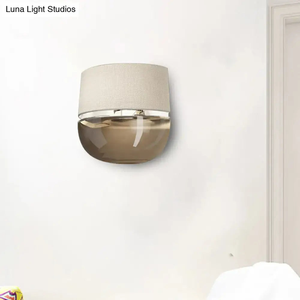 Amber arched tan glass sconce with a beige fabric shade by Decorbites on Tampa Home & Garden Store