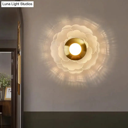 White Gold Flower Sconce by Decorbites; petal layered brass center wall light casts warm glow on Tampa Home & Garden Store