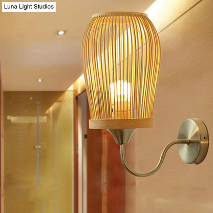 Bamboo Cage Wall Sconce by Decorbites, natural bamboo slat cage with brass arm and warm glow on Tampa Home & Garden Store