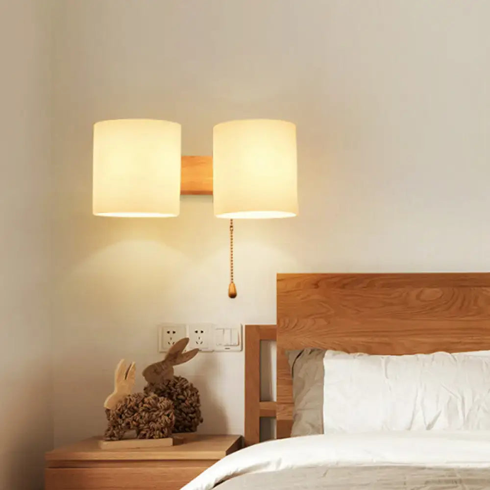 Beige fabric cylinder wall sconce by Decorbites with dual shades and wooden backplate on Tampa Home & Garden Store