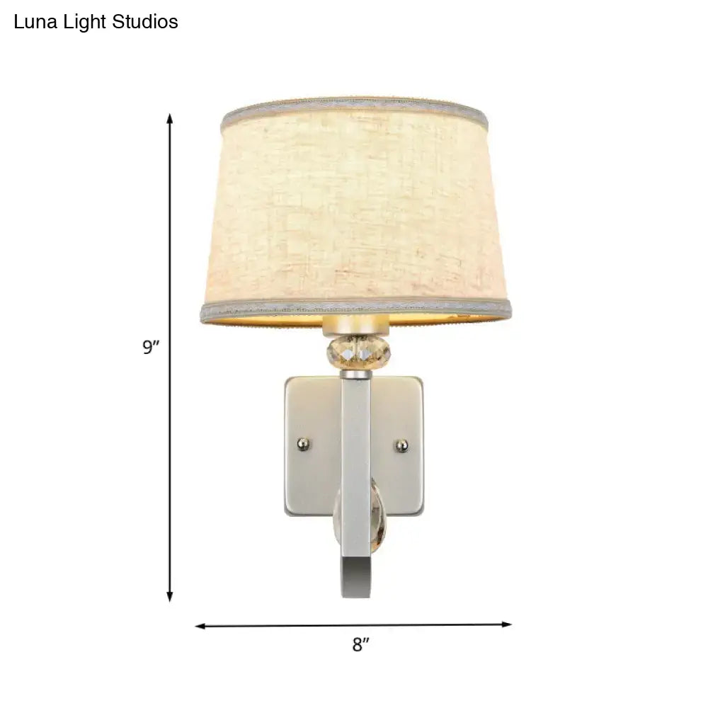 Beige crystal wall sconce with textured beige shade and silver metal mount by Decorbites on Tampa Home & Garden Store