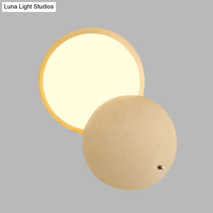 Decorbites gold metal wall lamp with a round illuminated disk and beige back plate on Tampa Home & Garden Store