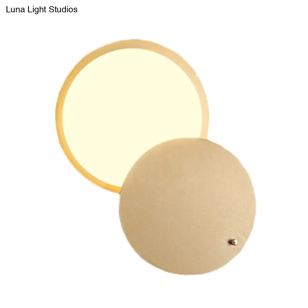 Gold metal wall lamp by Decorbites with a round glowing disk and circular backplate on Tampa Home & Garden Store