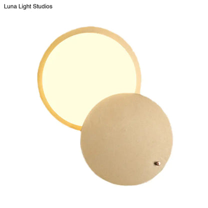 Gold metal wall lamp by Decorbites with a round glowing disk and circular backplate on Tampa Home & Garden Store