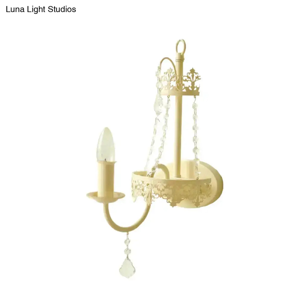 Modern beige ornate crystal sconce with candle bulb and hanging prisms, 15 in Decorbites on Tampa Home & Garden Store