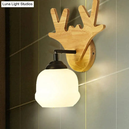 Wood deer head wall sconce with natural oak finish, black metal arm, frosted glass shade on Tampa Home & Garden Store