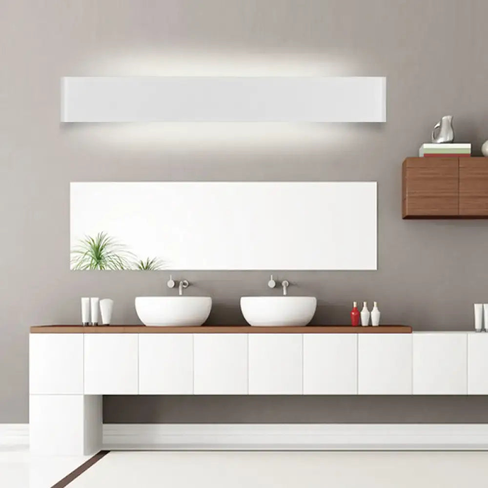 Black LED vanity sconce by Decorbites, sleek rectangular wall light over white double sink vanity on Tampa Home & Garden Store