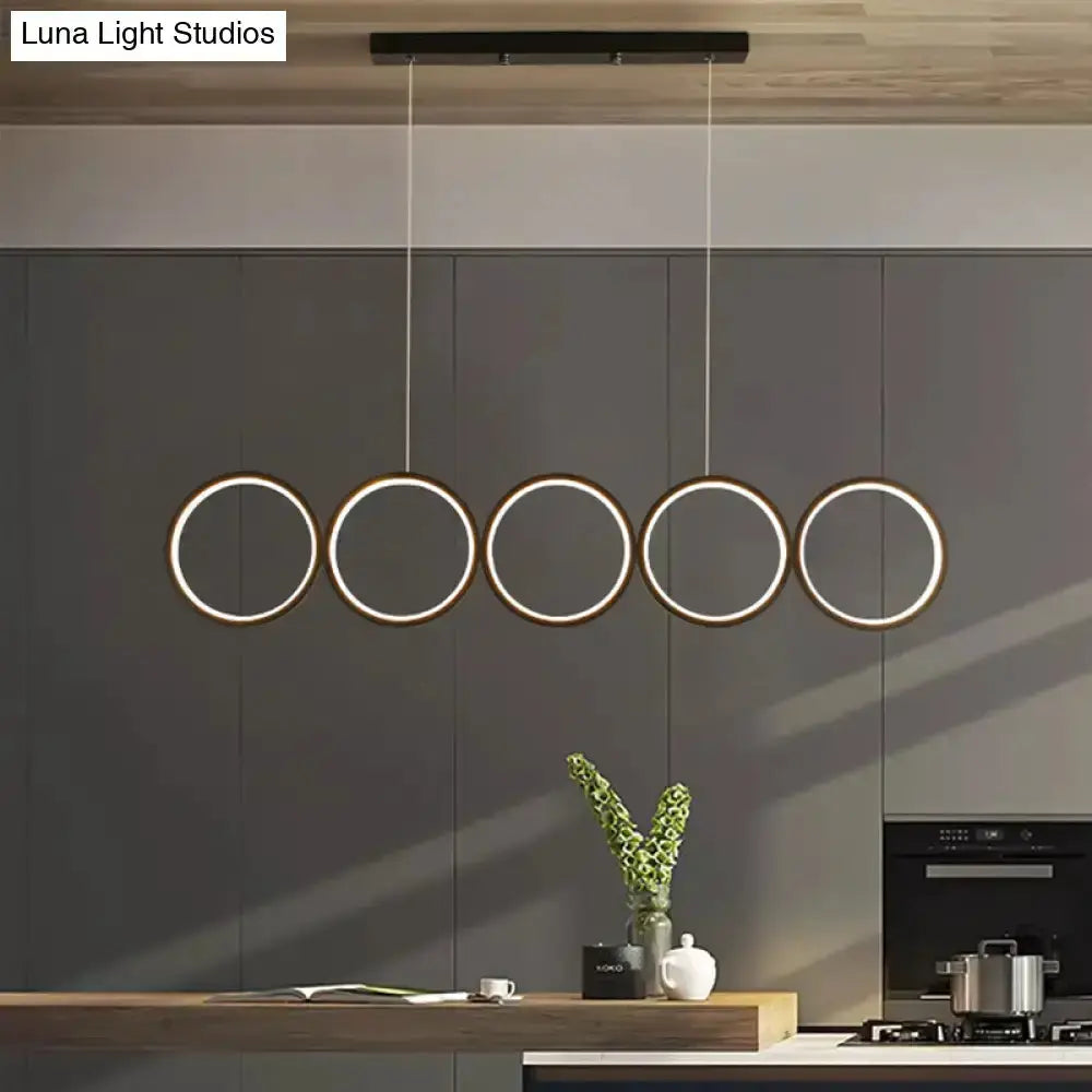 Decorbites modern black 5-ring LED pendant light over kitchen island on Tampa Home & Garden Store