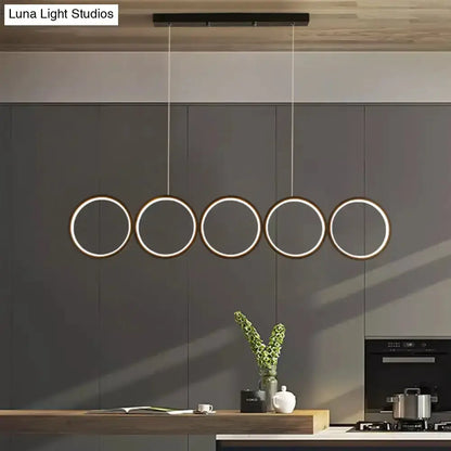 Decorbites modern black 5-ring LED pendant light over kitchen island on Tampa Home & Garden Store
