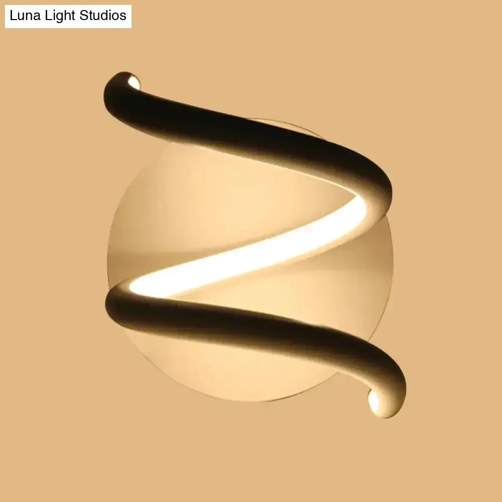 Modern black acrylic spiral sconce with warm LED glow and round back plate Decorbites on Tampa Home & Garden Store