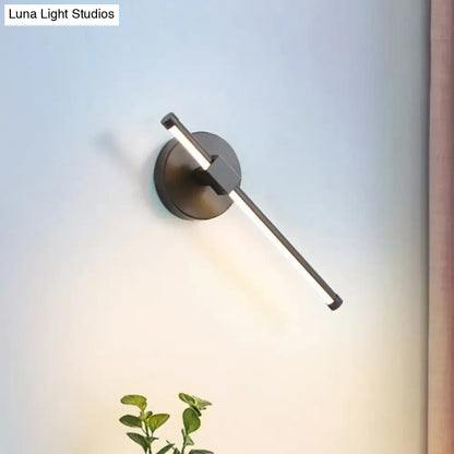 Black acrylic tube wall sconce with circular backplate by Decorbites; Luna Light Studios label on Tampa Home & Garden Store