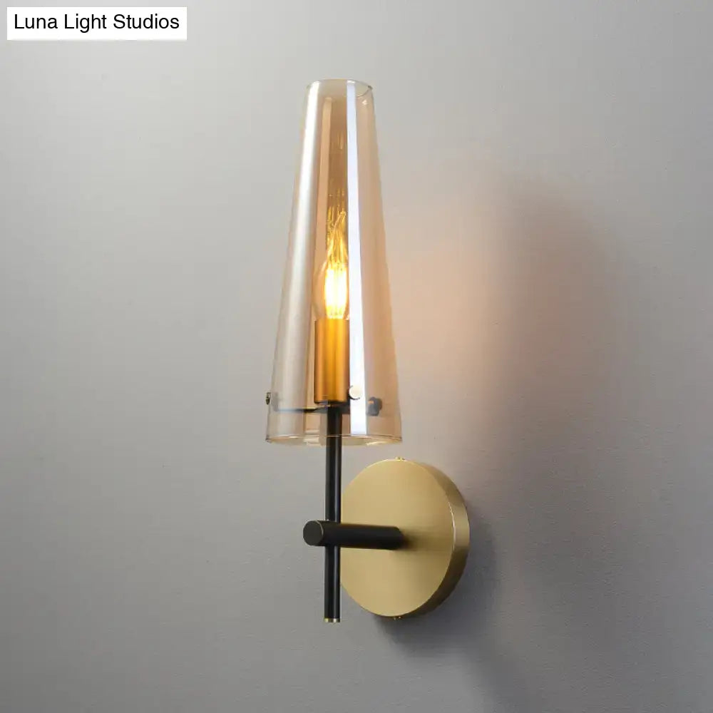 Decorbites black brass wall mount sconce with clear glass cone shade and exposed Edison bulb on Tampa Home & Garden Store