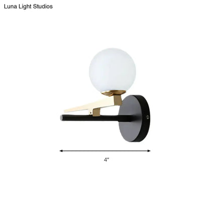 Decorbites black white spherical glass sconce with brass arm and black backplate 4-inch wide on Tampa Home & Garden Store