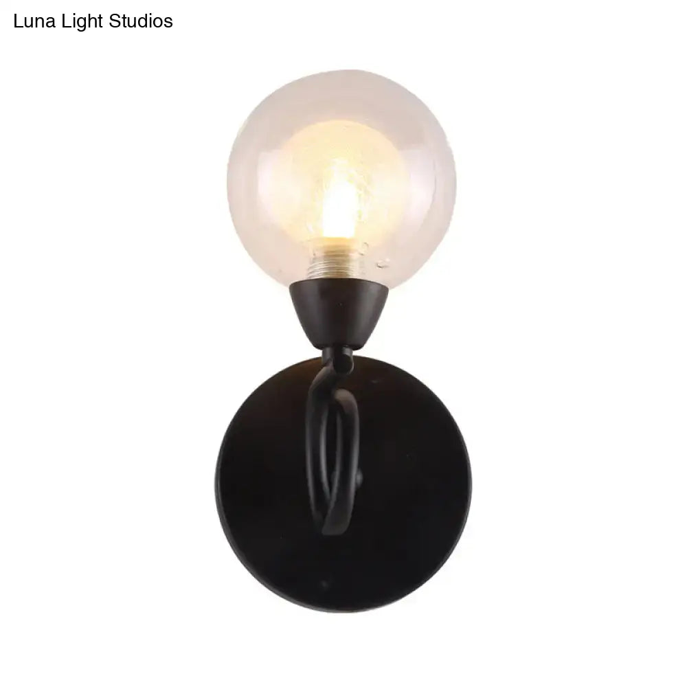 Black wall lamp with clear glass globe on round black wall mount Decorbites on Tampa Home & Garden Store