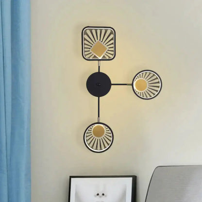 Modern black and gold sunburst LED three-light wall sconce by Decorbites with round shades on Tampa Home & Garden Store