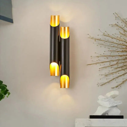 Decorbites Black Gold Tubular wall sconce with stacked black metal tubes and gold interior glow on Tampa Home & Garden Store