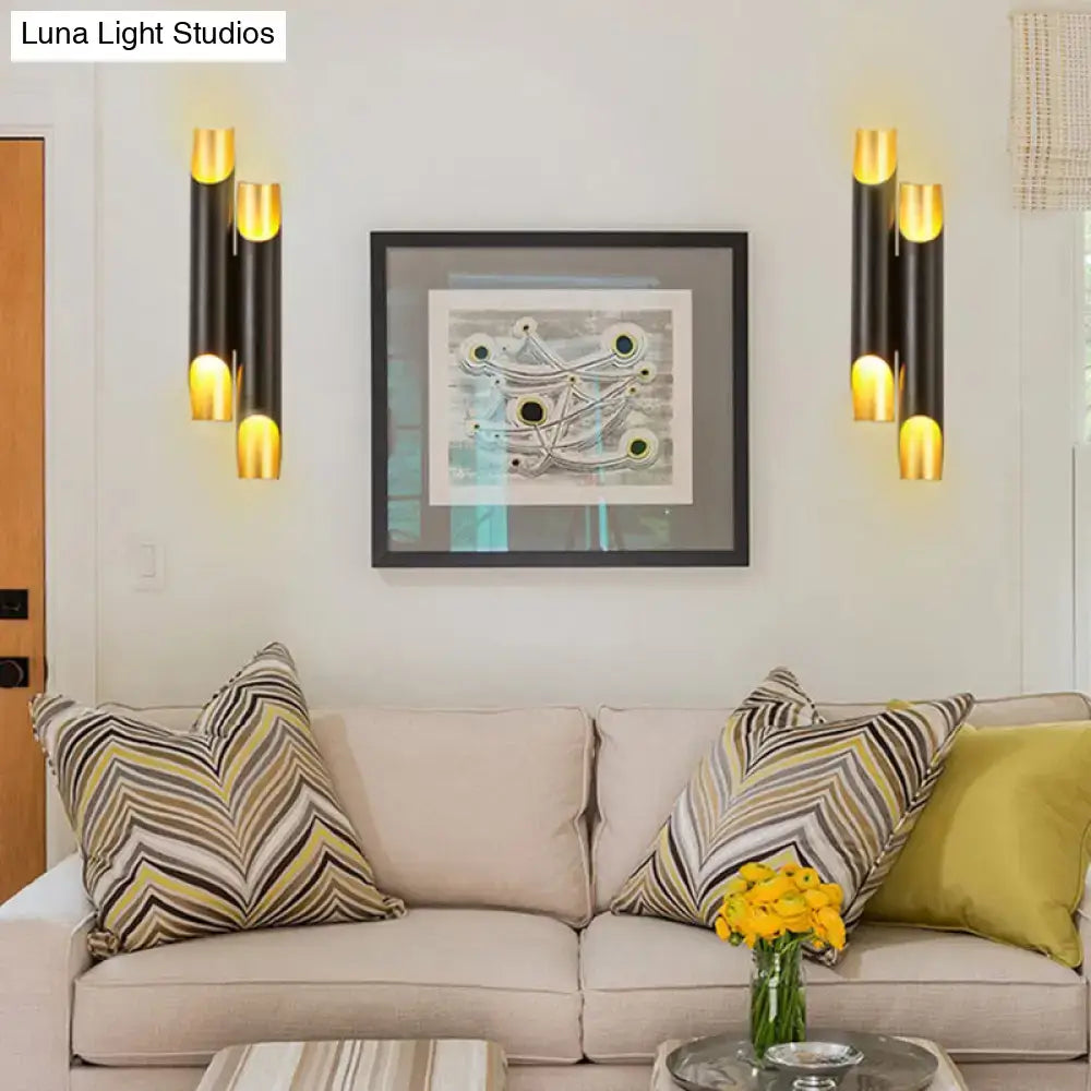 Black gold tubular wall sconces set of four flanking a framed abstract artwork, modern lighting on Tampa Home & Garden Store