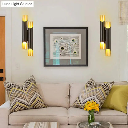 Black gold tubular wall sconces set of four flanking a framed abstract artwork, modern lighting on Tampa Home & Garden Store