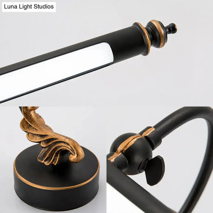 Modern black and gold tubular LED bathroom wall sconce with ornate gold-accent base on Tampa Home & Garden Store
