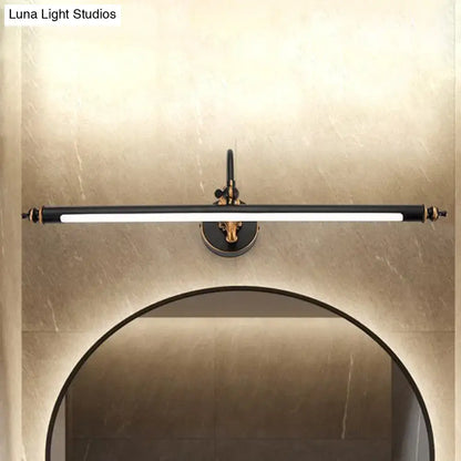 Modern black and gold tubular LED bathroom wall sconce mounted above a circular mirror on wall on Tampa Home & Garden Store