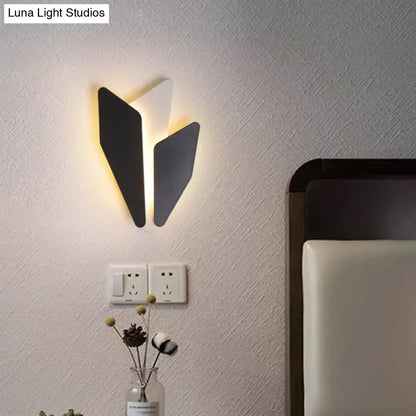 Black geometric metal wall light with three angular panels and warm glow by Decorbites on Tampa Home & Garden Store