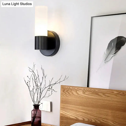 Black Glass Warm-Glow Wall Sconce with cylindrical frosted shade on a round black mount on Tampa Home & Garden Store