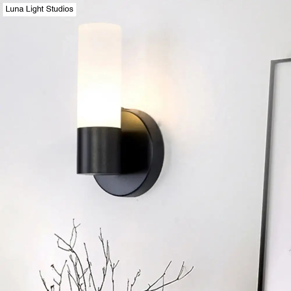 Black Glass Warm-Glow Wall Sconce with frosted cylindrical shade and black metal mount on Tampa Home & Garden Store