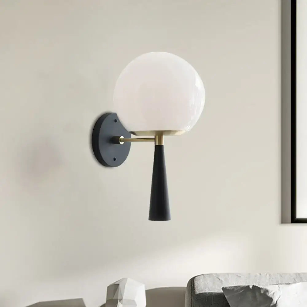 Black Globe Compact Wall Sconce with white glass globe and brass arm on Tampa Home & Garden Store
