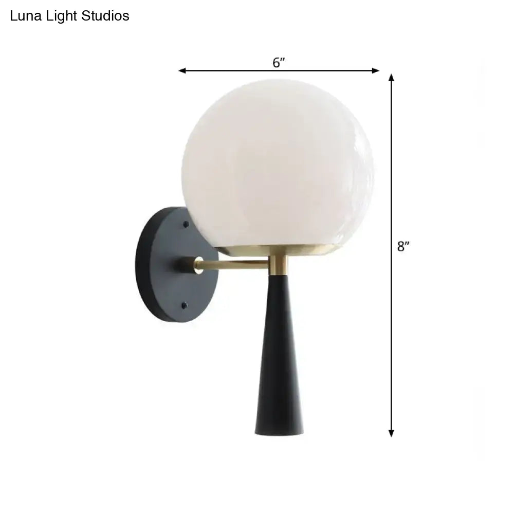 Black globe compact wall sconce Decorbites with frosted glass globe and brass arm on Tampa Home & Garden Store