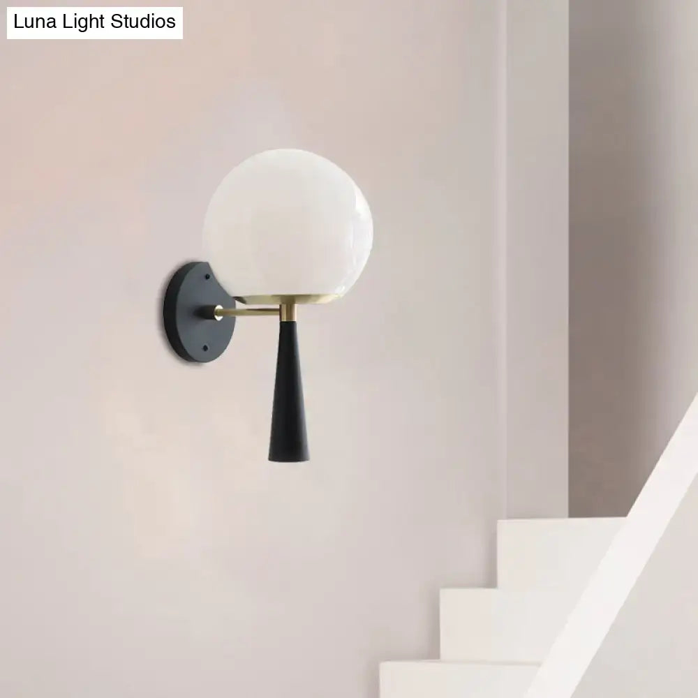 Black Globe Compact Wall Sconce Decorbites with white glass globe shade brass arm black backplate on Tampa Home & Garden Store