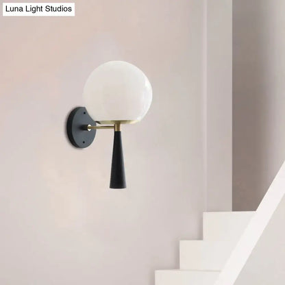 Black Globe Compact Wall Sconce Decorbites with white glass globe shade brass arm black backplate on Tampa Home & Garden Store