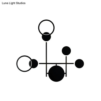 Black metallic wall sconce with geometric rings and discs for a modern sculptural look on Tampa Home & Garden Store