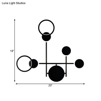 Black metallic wall sconce with circular and ring accents, geometric multi-arm design, 18x20 in on Tampa Home & Garden Store