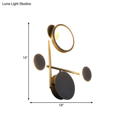 Black metallic wall sconce by Decorbites with brass ring light and circular backplates, geometric on Tampa Home & Garden Store