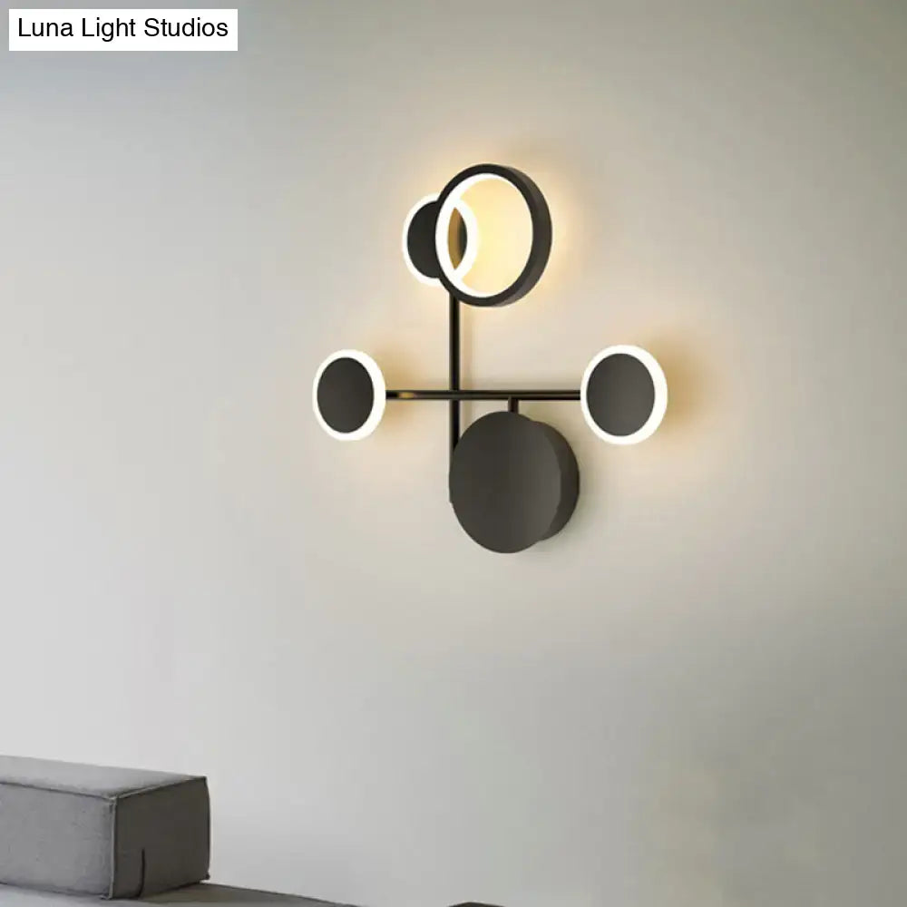 Black metallic wall sconce by Decorbites with circular discs and halo LED rings on Tampa Home & Garden Store
