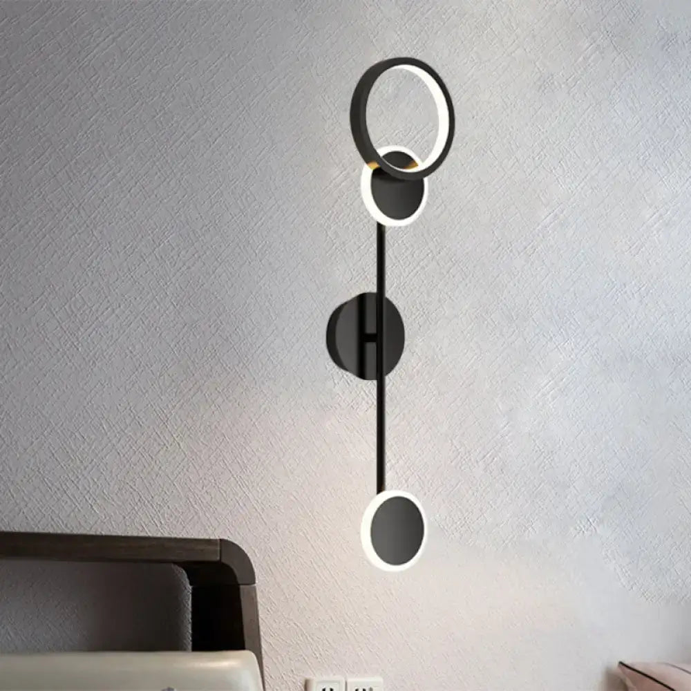 Black metallic wall sconce by Decorbites with stacked circular rings and LED accents on Tampa Home & Garden Store