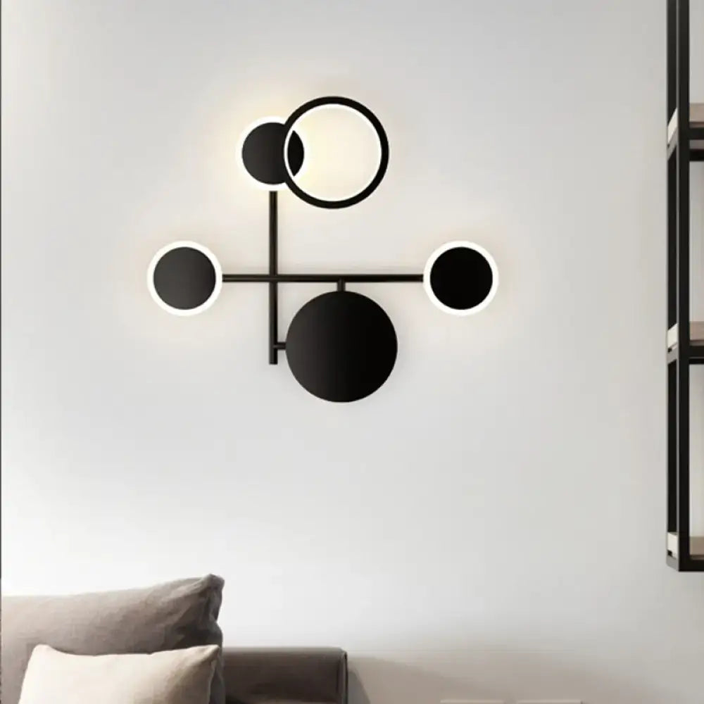 Black metallic wall sconce Decorbites with geometric circle motif and LED halo on Tampa Home & Garden Store
