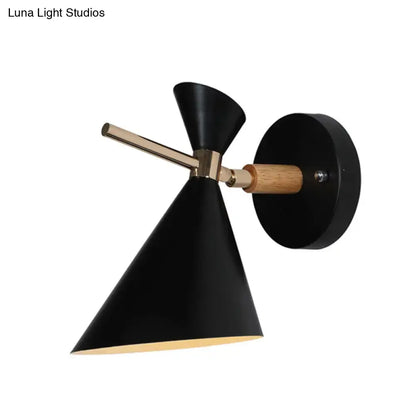 Black angled wall sconce with conical shade, brass hardware, and wood accent on Tampa Home & Garden Store