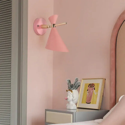 Decorbites black angle wall sconce with pink cone shade and wood arm on Tampa Home & Garden Store