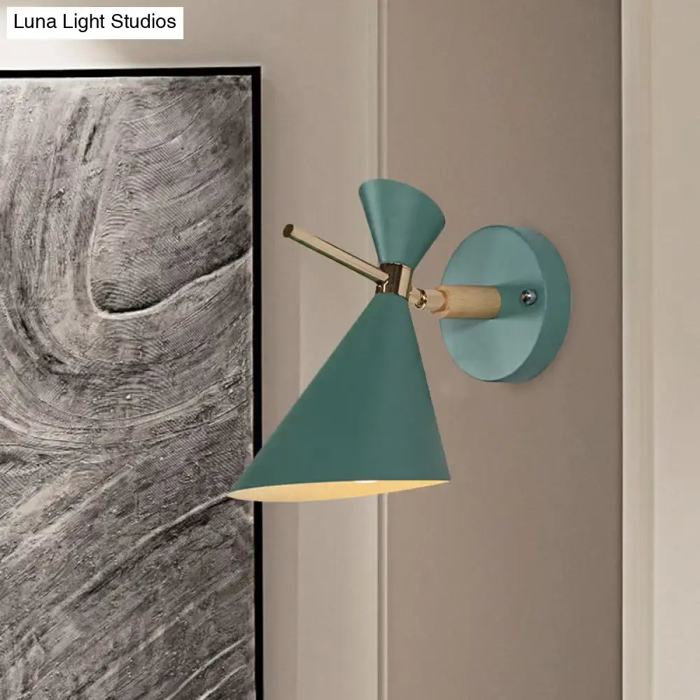 Black angle wall sconce by Decorbites with teal shade and brass arm, wall-mounted on Tampa Home & Garden Store